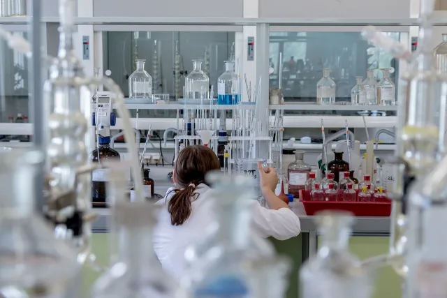 Students working in a modern university science laboratory for graduate research