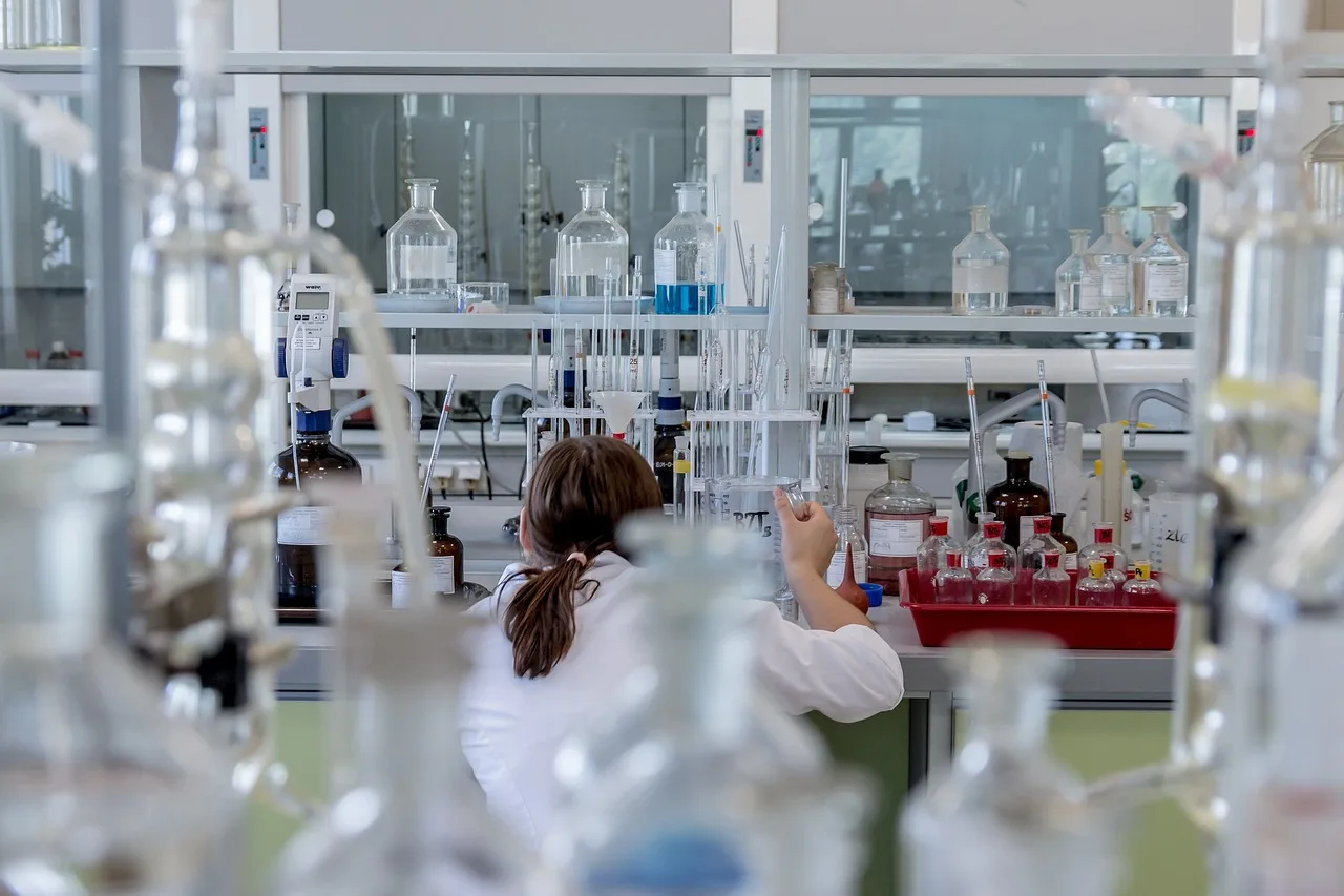 Students working in a modern university science laboratory for graduate research