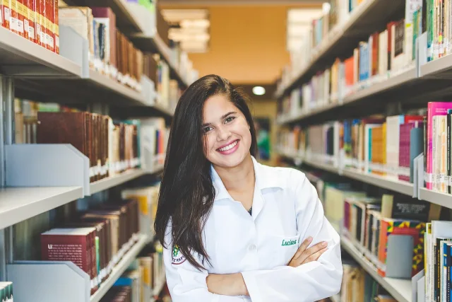 Pakistani PhD scholars studying in a university library for international fellowships.