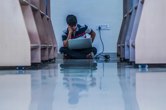 Pakistani student using a laptop for learning and planning with AI tools
