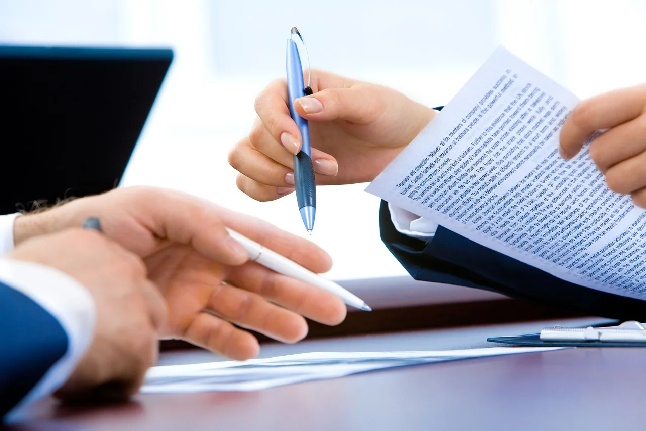 Professional office desk with application documents and official notices for government hiring.