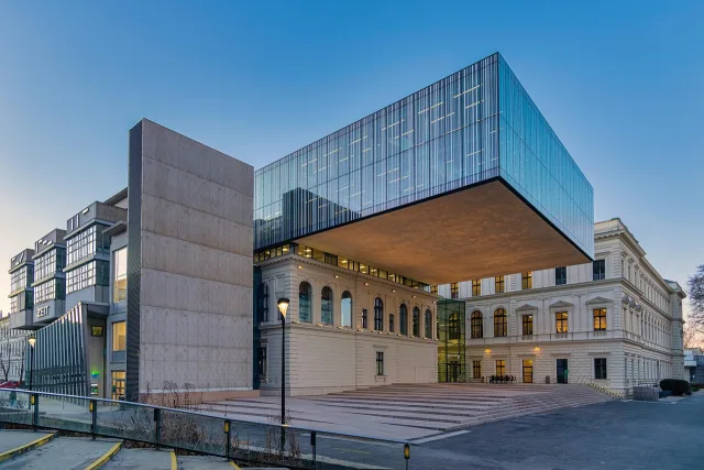 Students walking near a modern university building representing global higher education