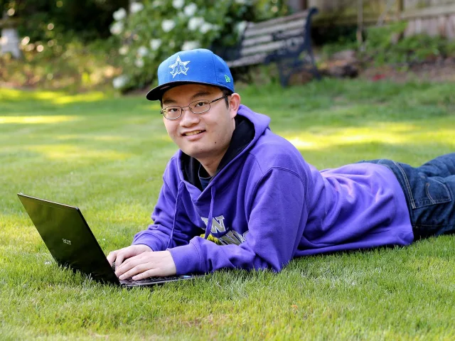Students reviewing US university admission and international work policy updates on a laptop